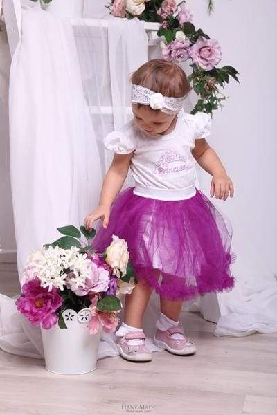 little girl in a violet tutu skirt 